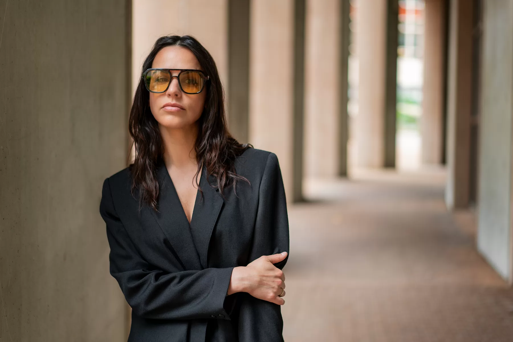 Environmental portrait of actor Kara Crabb wearing a blazer and glasses in Vancouver
