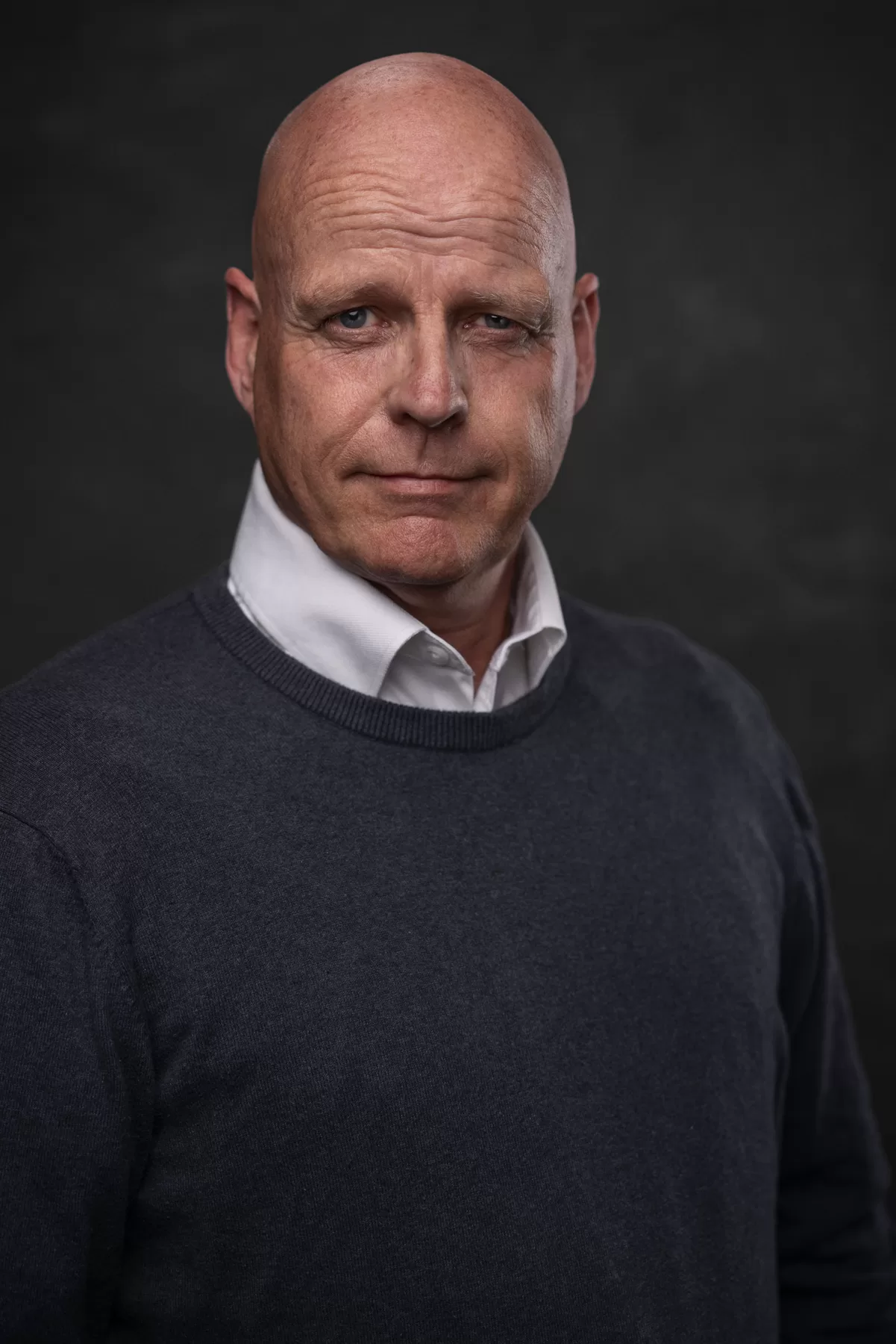 Studio actor headshot of Matt Evans wearing a navy sweater