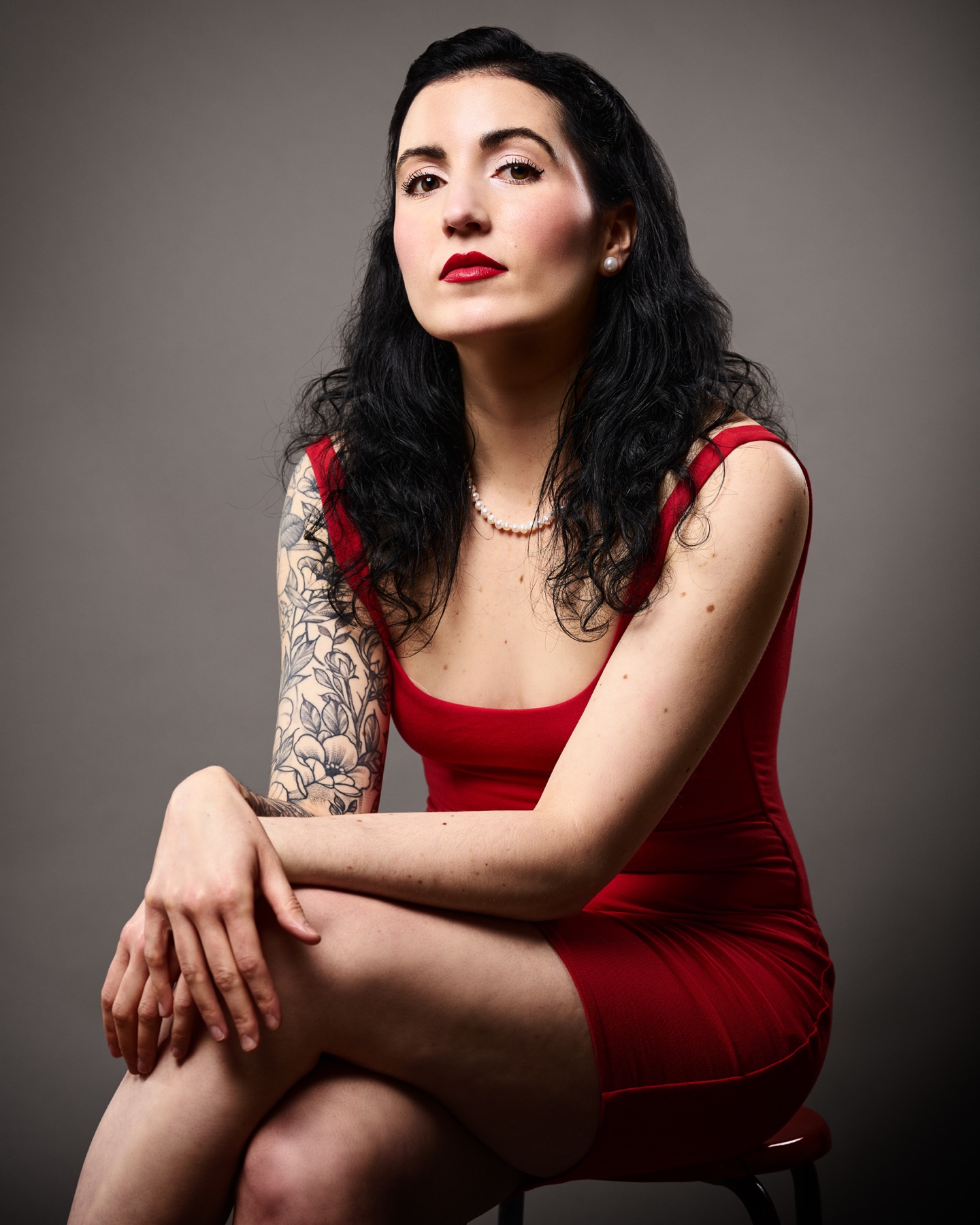 Artist press portrait of Monique Angele wearing a red dress