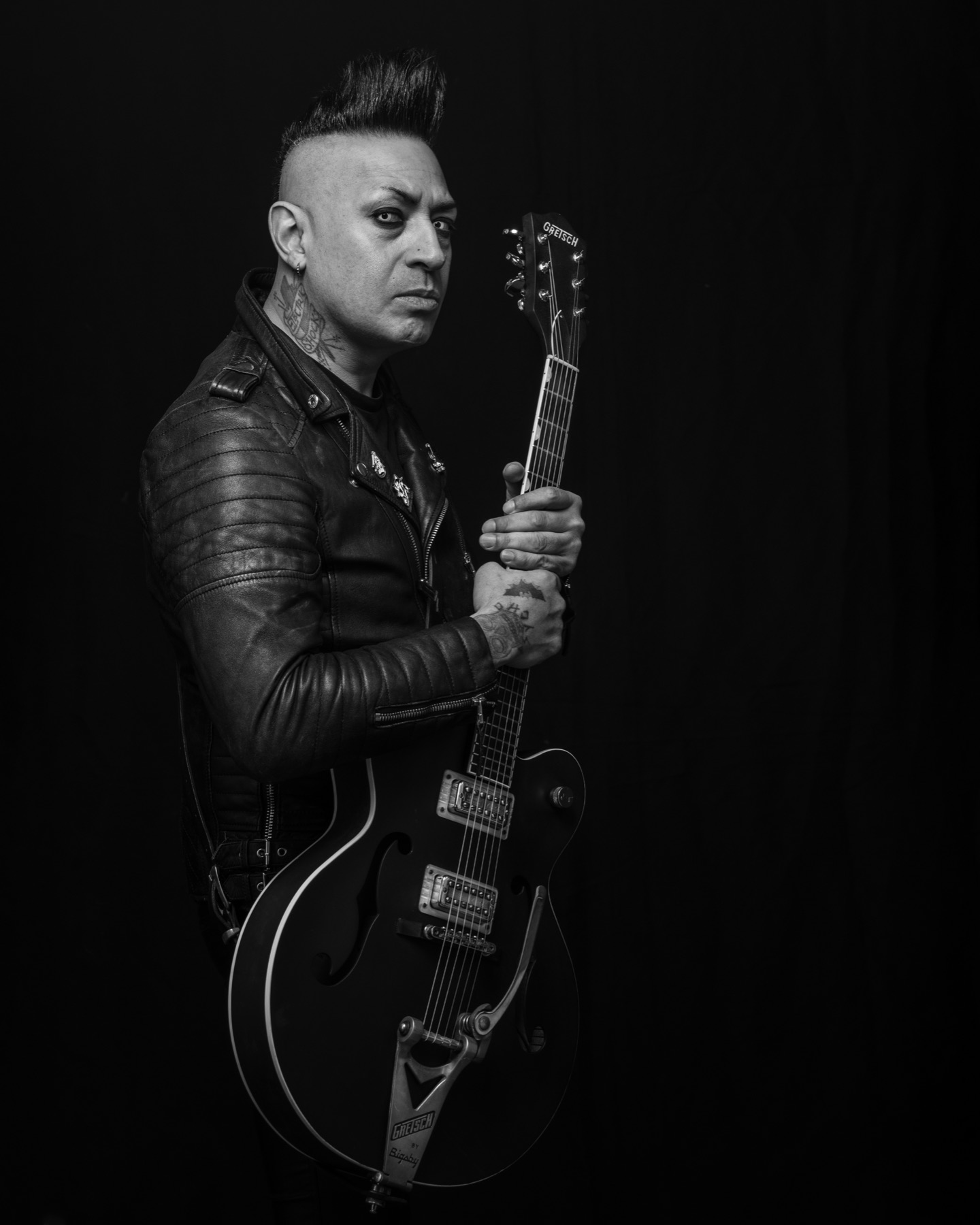 Black and white promotional portrait of a guitarist from Montreal band The Brains holding a Gretsch guitar