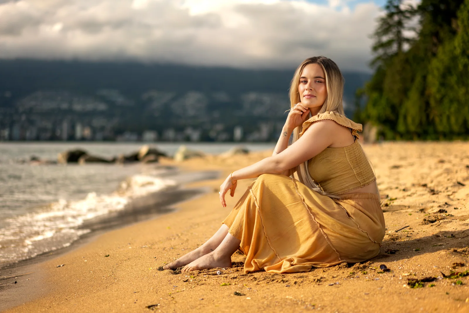 Actor Camille Felton seated on a sunlit Vancouver beach