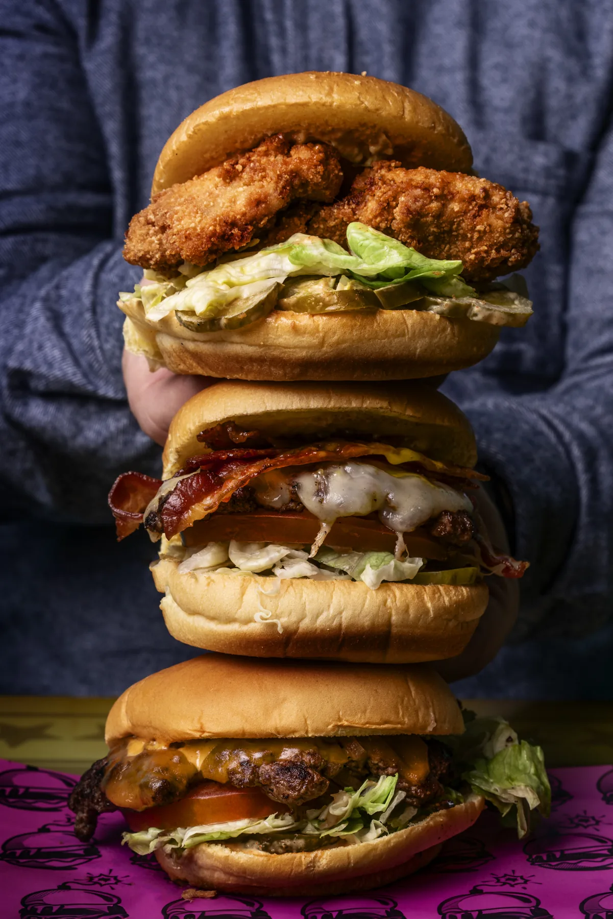 Stack of restaurant burgers photographed for a Vancouver food brand