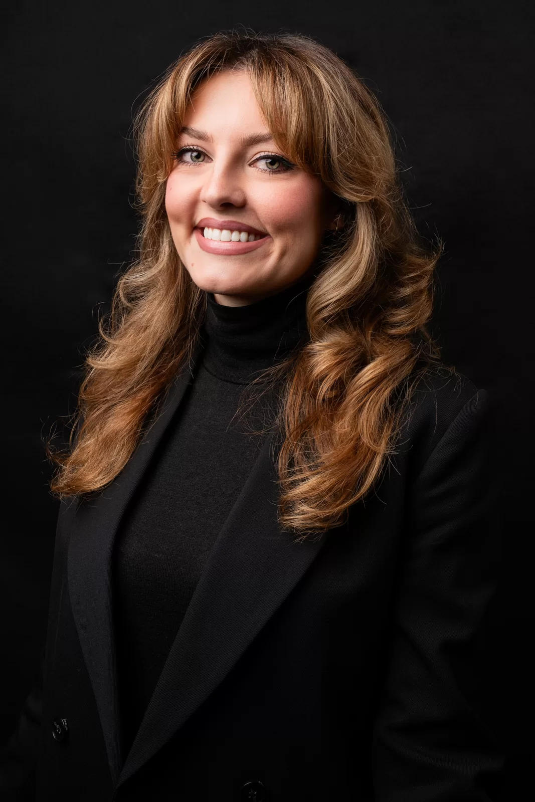 Promosa team headshot against a dark studio background