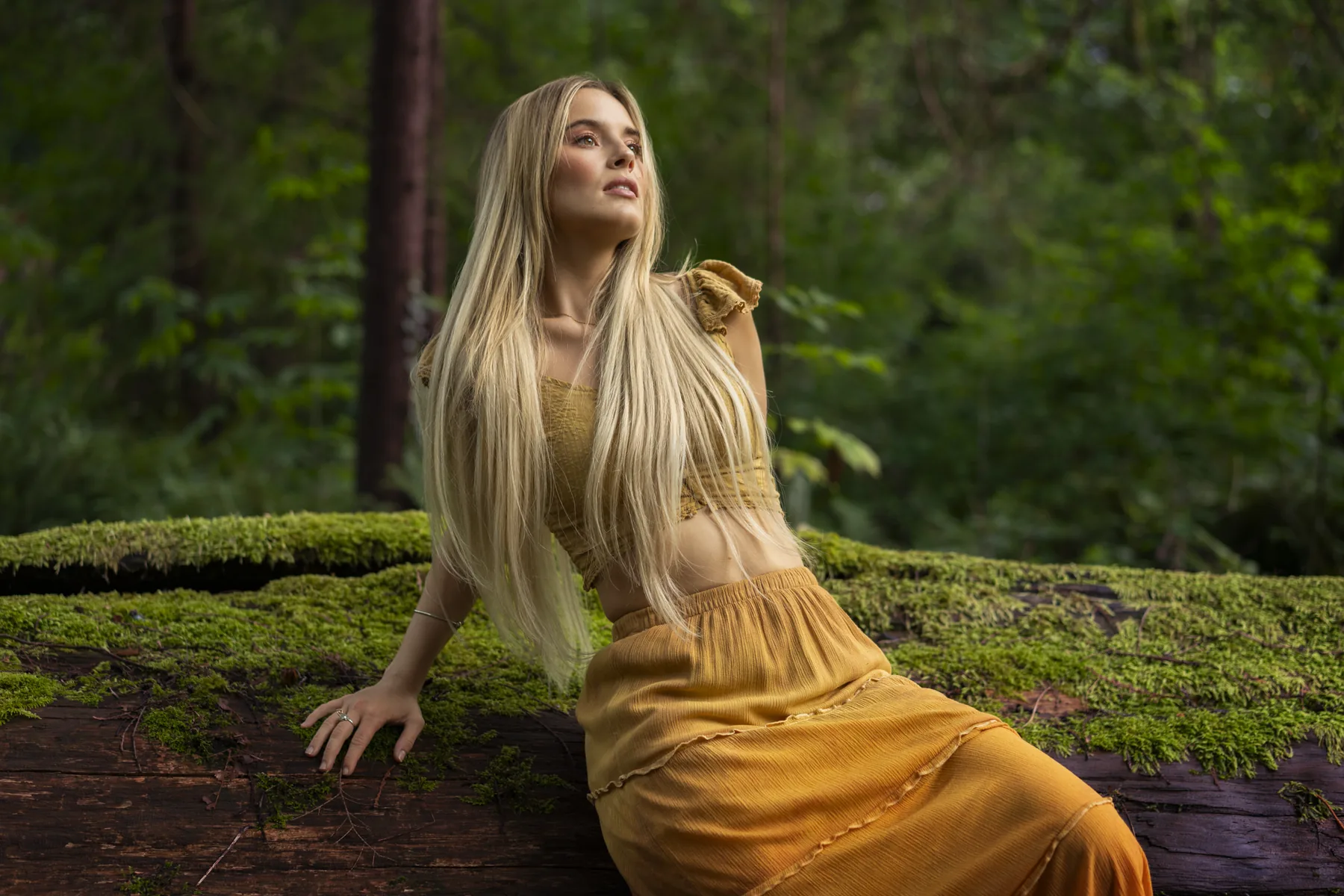 Environmental editorial portrait of a woman in gold in a Vancouver forest