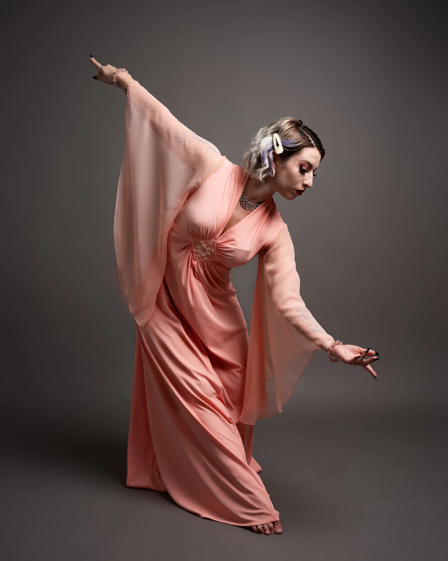 Movement-led editorial portrait of a dancer in a flowing pink gown