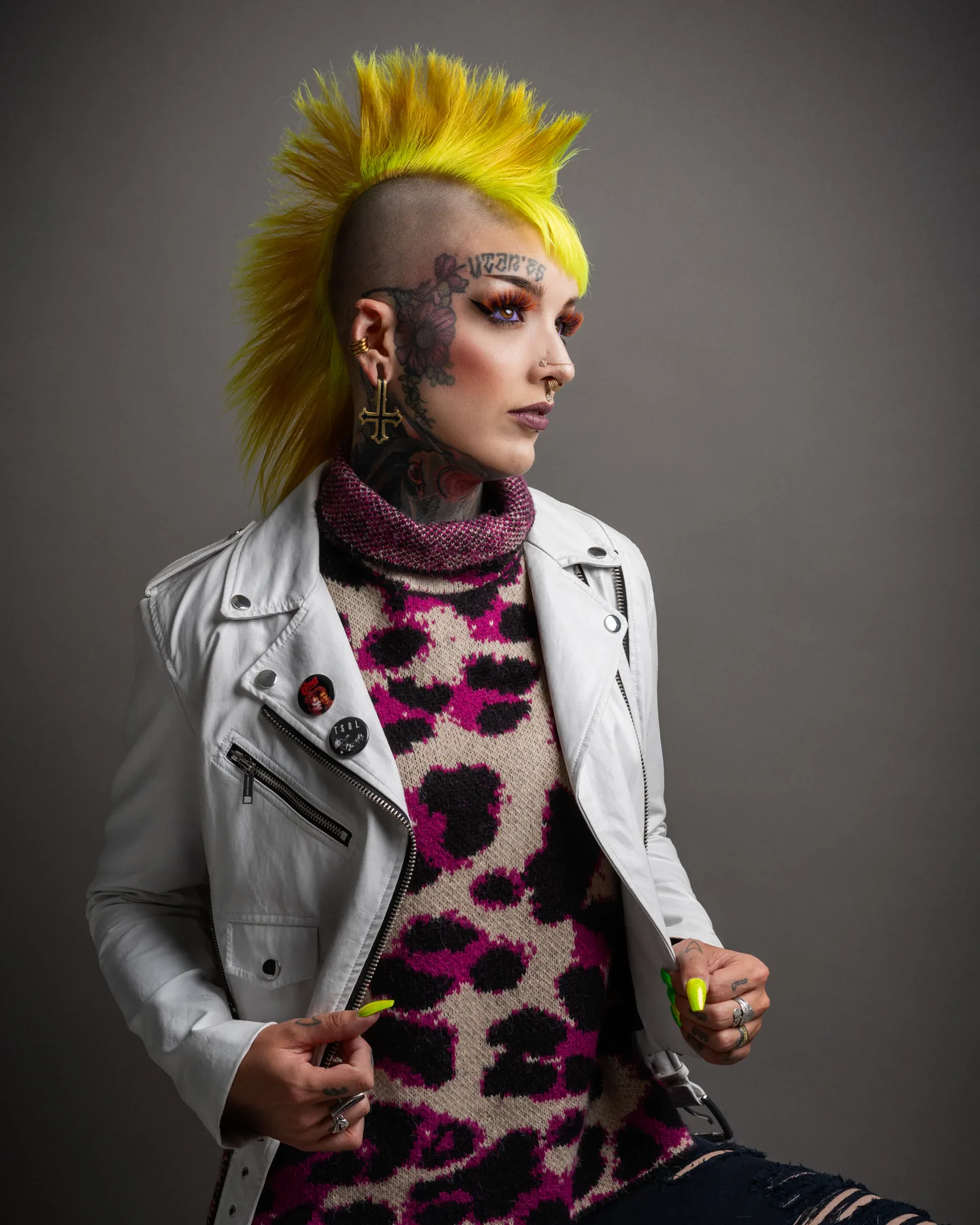 Creative studio portrait of a punk artist with vivid yellow hair