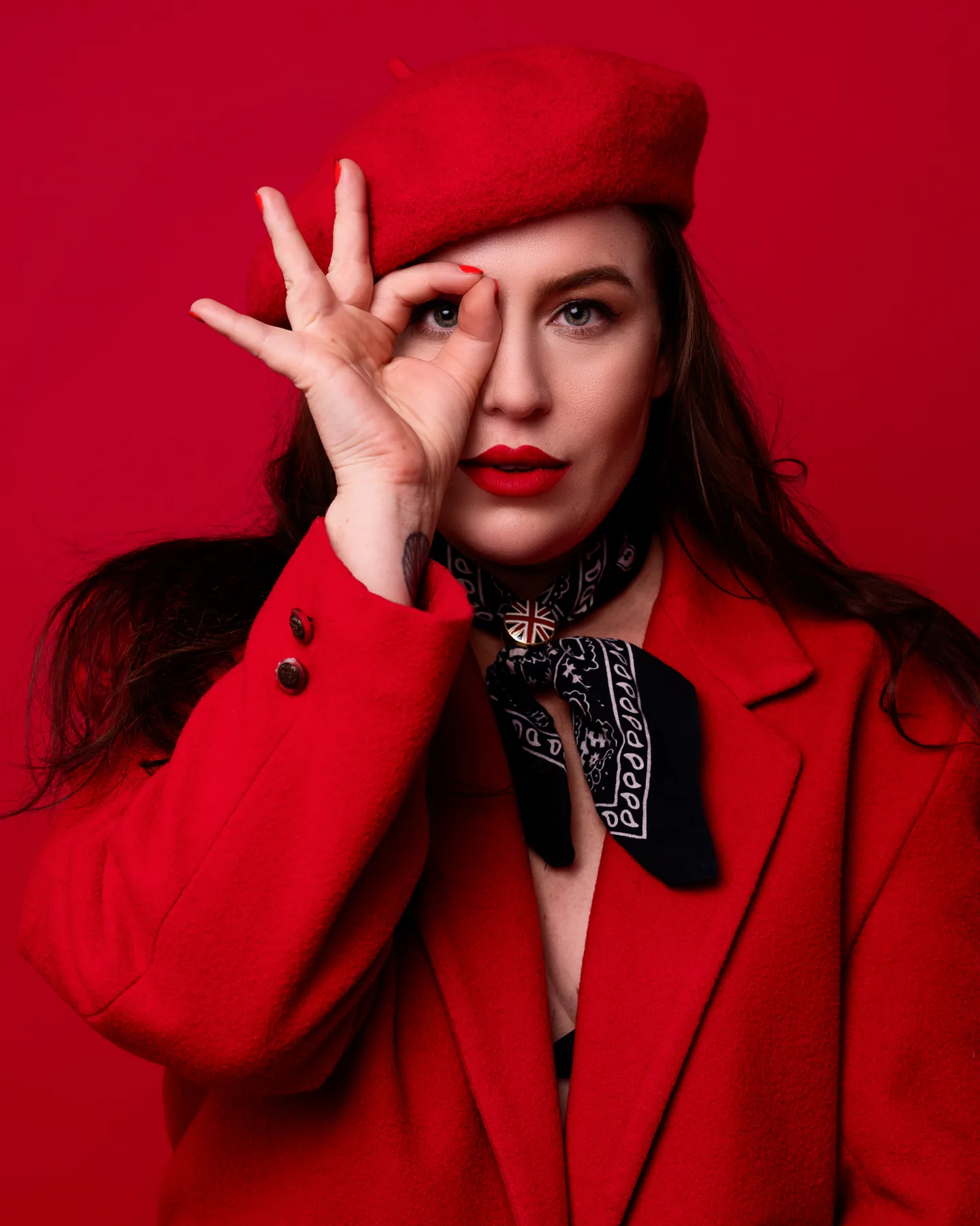 Fashion portrait of a woman in a red beret and red coat