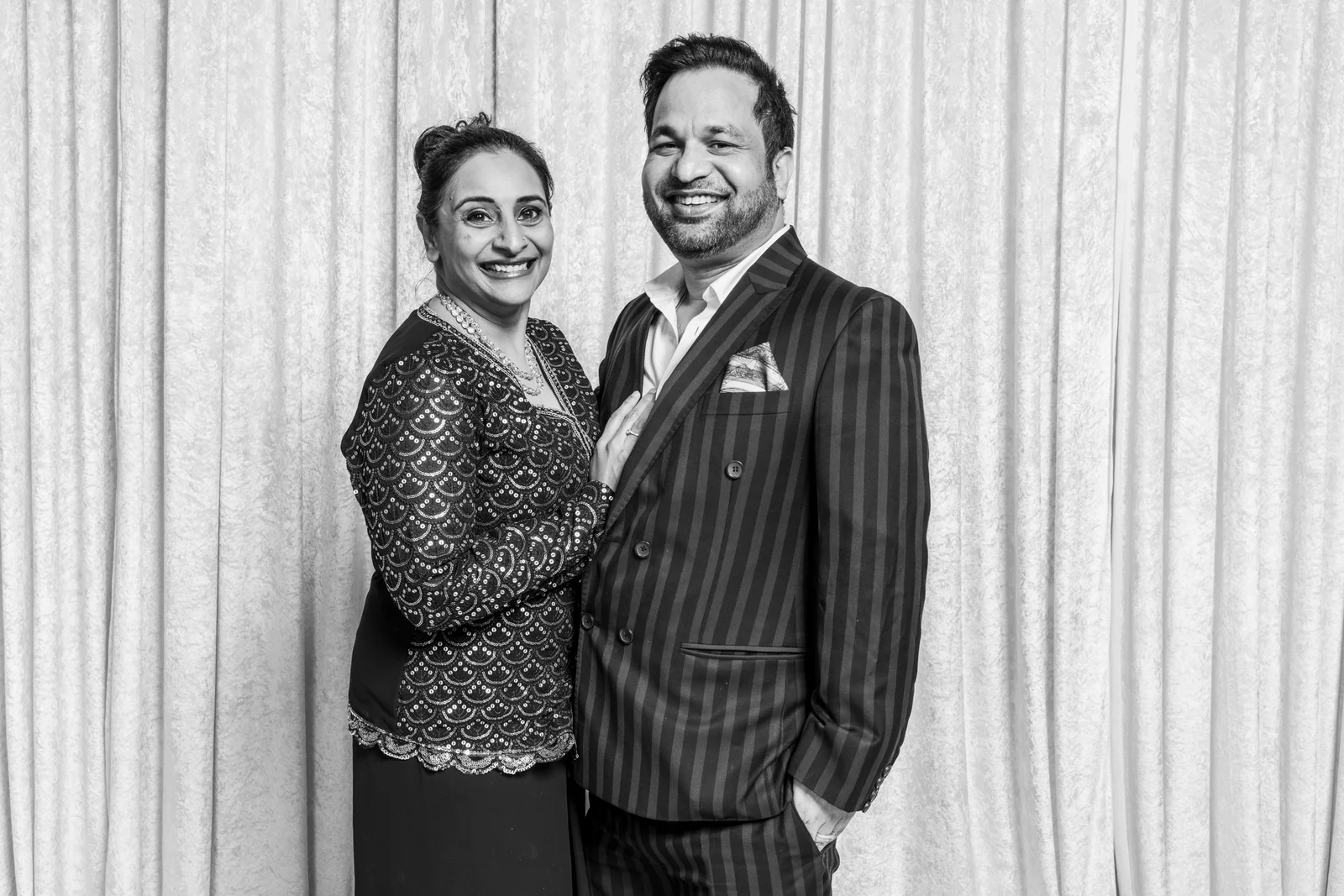 A smiling couple photographed together at the wedding