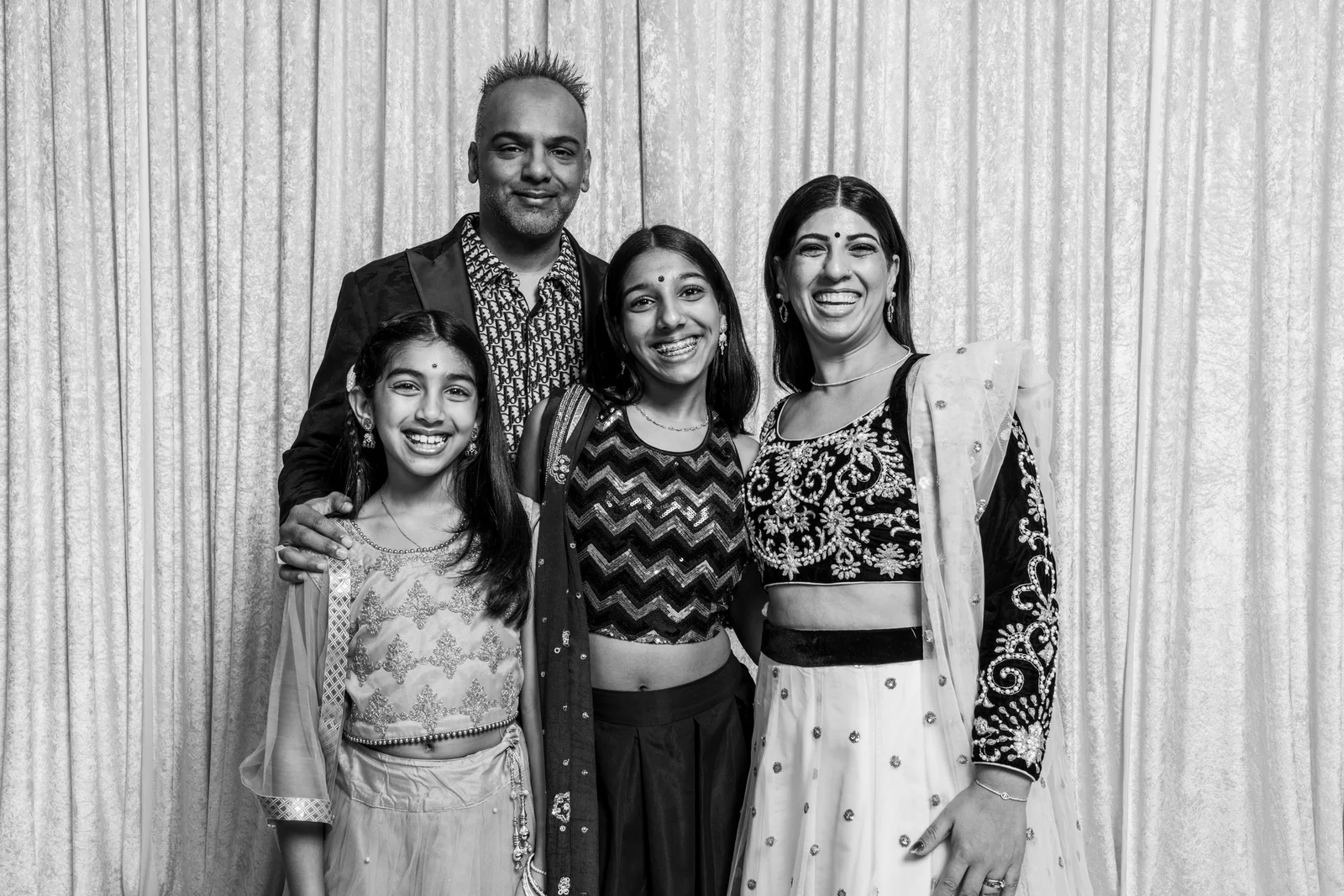 Four family members laughing together for their event portrait