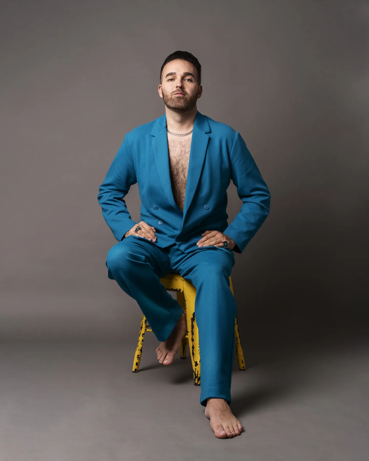 Full-length personal branding portrait of a man in a blue suit
